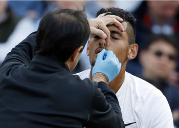 Nick Kyrgios of Australia receives medical attention during his men's singles match against Feliciano Lopez of Spain on day six of the Wimbledon Tennis Championships in London, Saturday, July 2, 2016. (AP Photo/Alastair Grant)