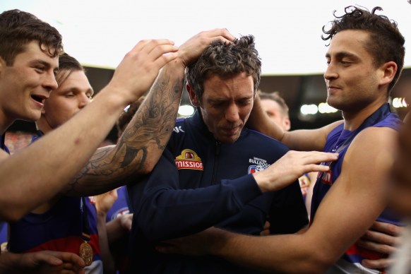 An emotional Murphy is swamped by teammates after the match.