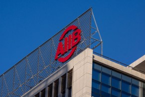 BEIJING, CHINA - 2016/01/18: AIIB logo on its headquarter in Beijing financial street. The Asian Infrastructure Investment Bank (AIIB) officially launched on January 16, 2016. The AIIB is expected to lend $10 billion-$15 billion a year for the first five or six years and will start operations in the second quarter of 2016. (Photo by Zhang Peng/LightRocket via Getty Images)