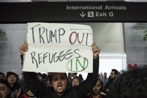 People gather for a protest at the Arrivals Hall of San Francisco's SFO International Airport 