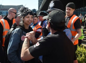 Saffiyah Khan (left) staring down English Defence League protester Ian Crossland during a Birmingham demonstration.
