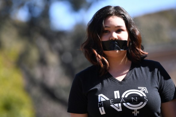 A university student is pictured protesting at the Australian National University in Canberra on Tuesday