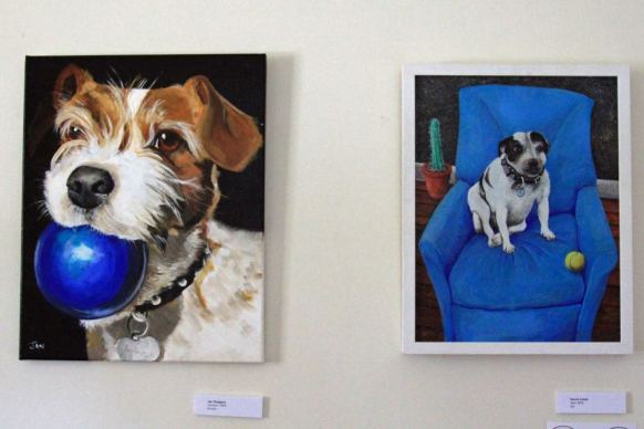 Paintings of dogs with balls in the picture