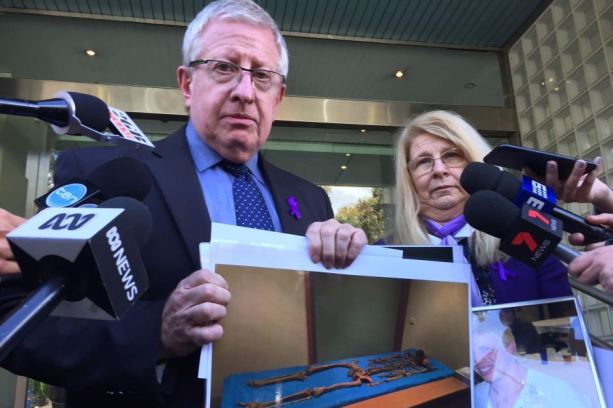 Mark and Faye Leveson with a picture of the remains of their son Matthew Leveson.