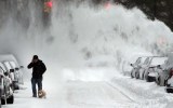 A man and his dog contend with blowing snow in Brooklyn.