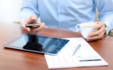 person multitasking coffee ipad phone