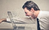 man smashes laptop