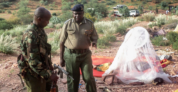 Security officers stand next to a mosquito net used by a quarry worker.