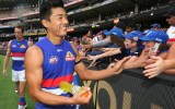 Doggies Lin Jong high fives fans after beating Richmond.