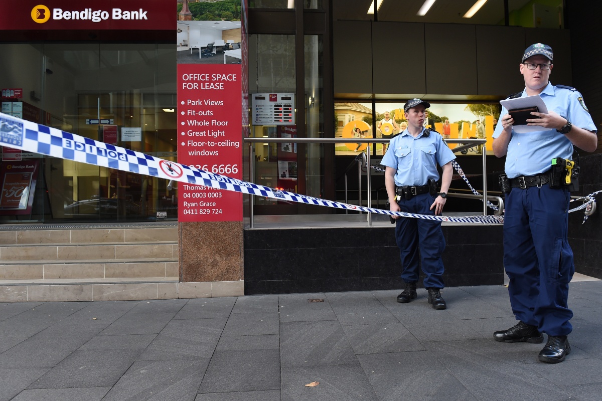 Police officers guard a crime scene following a robbery at a Sydney bank.