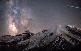 A meteor can be seen piercing through the darkness as the Milky Way towers above the 4,392m peak of Mount Rainier in Washington, USA.