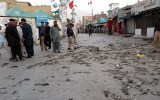Officials inspect the site of a roadside bomb blast in Pakistan, Wednesday.