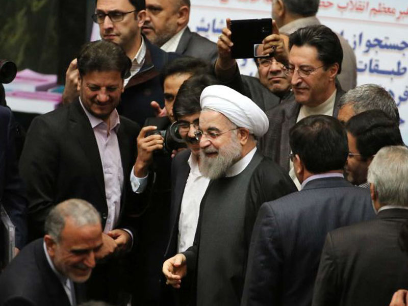 Iranian President Hassan Rouhani (c) arrives to parliament.