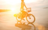 female cyclist no helmet beach