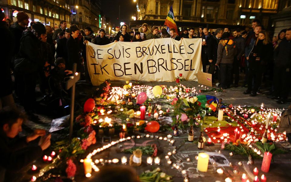 People hold up a banner as a mark of solidarity at the Place de la Bourse in Brussels.