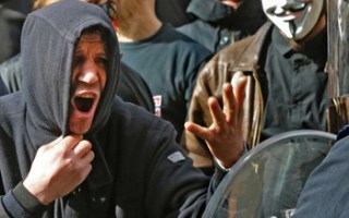 Police used a water cannon against a group that burst onto the vigil shouting anti-migrant slogans.