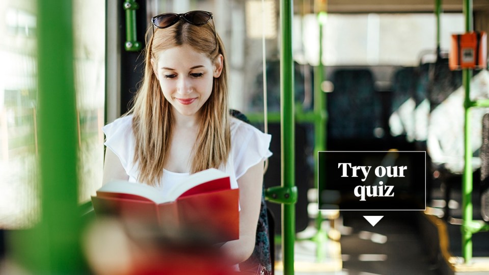 Woman is reading a book while commuting