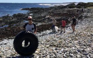 Volunteers collecting rubbish from a remote Tasmanian beach