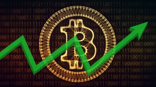 A bitcoin logo behind a graph.