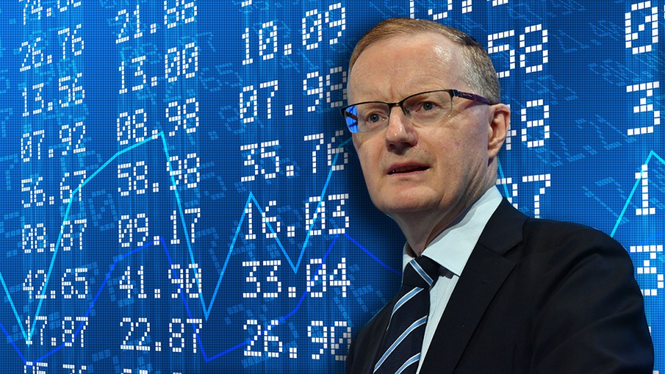 Philip Lowe stands in front a screen of financial data.