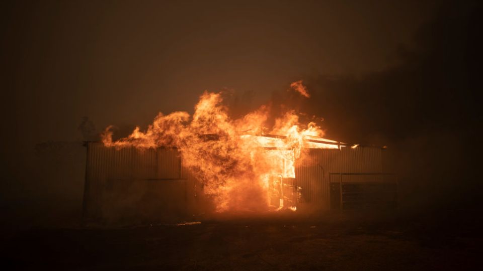 A bushfire ravages property near Canberra.
