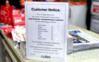 A message to customers at a Coles supermarket limiting purchases of some products.