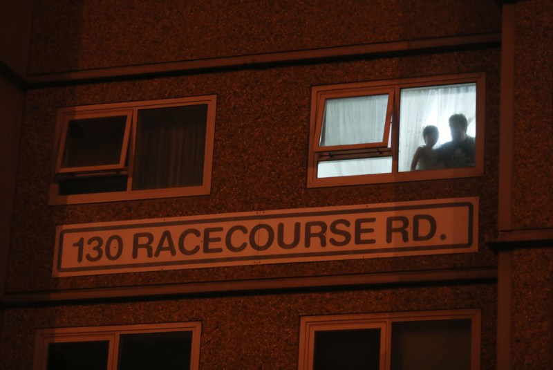 Residents watch from their window as police enforce a lockdown at public housing towers in Melbourne.