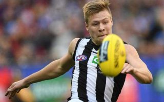 Collingwood player Jordan de Goey goes for the football