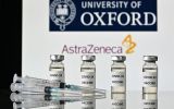 An illustration picture shows vials with Covid-19 Vaccine stickers attached and syringes, with the logo of the University of Oxford and its partner British pharmaceutical company AstraZeneca, on November 17, 2020. (Photo by JUSTIN TALLIS / AFP) (Photo by JUSTIN TALLIS/AFP via Getty Images)
