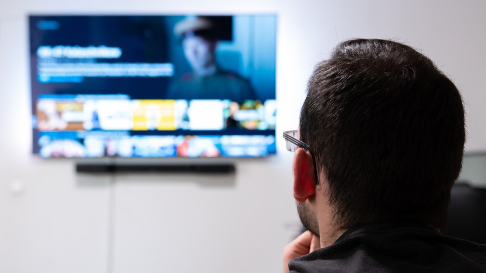 Pictured is a man watching a streaming service, like Netflix or Binge