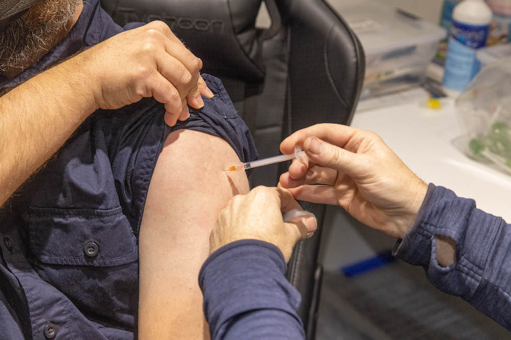 Pictured is a man getting his Covid booster shot