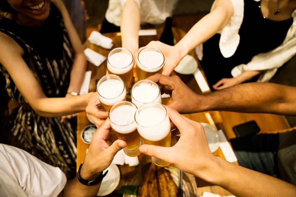 Pictured is a group of people with beers, to illustrate what comes before a hangover