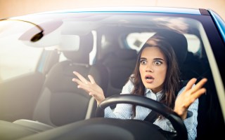 Frustrated woman stuck in traffic.