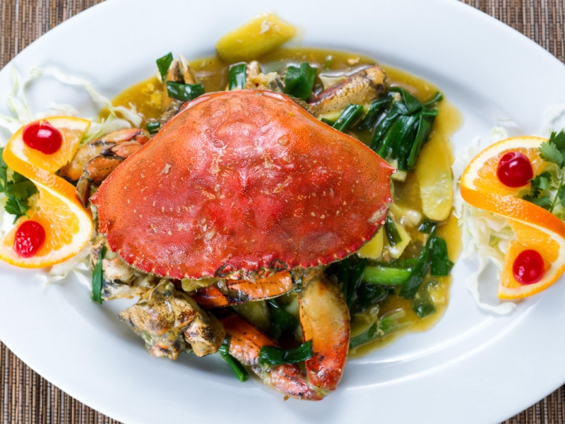 Freshly cooked whole Dungeness crab in green onion sauce