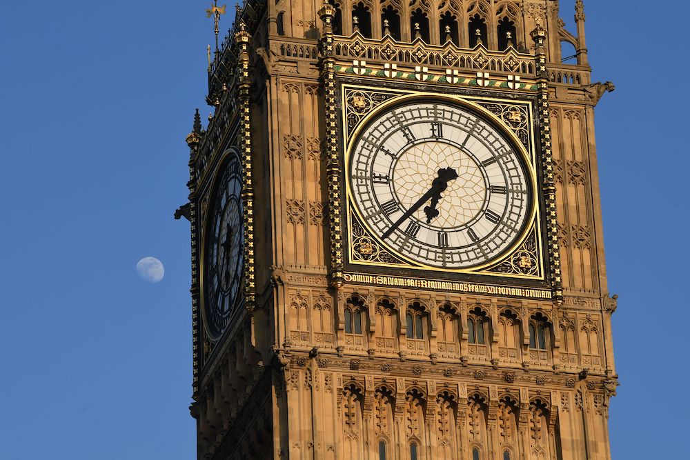 A picture shows the clockface of Elizabeth Tower, commonly referred to by the name of the bell Big Ben and the Moon