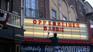 Pictured is a cinema sign saying Barbie and Oppenheimer