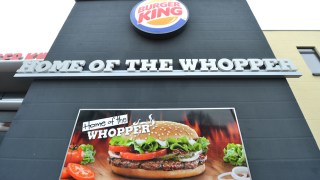 An advertisement reading 'Home of the Whopper is seen at a closed down Burger King restaurant