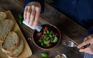 pictured is someone adding salt